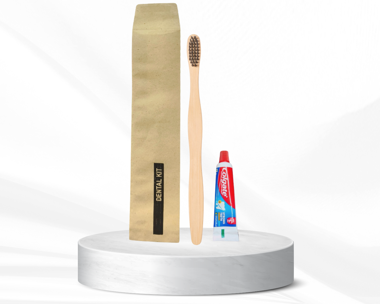 Dental kit with bamboo toothbrush, toothpaste, and pouch on a white platform, featuring ecomfd branding.
